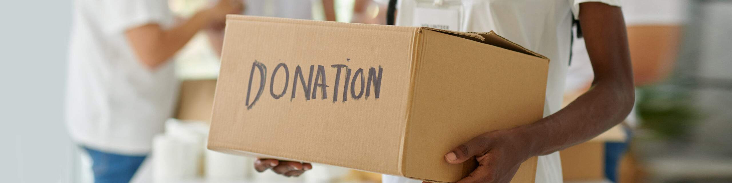 Volunteer holding a box of donations