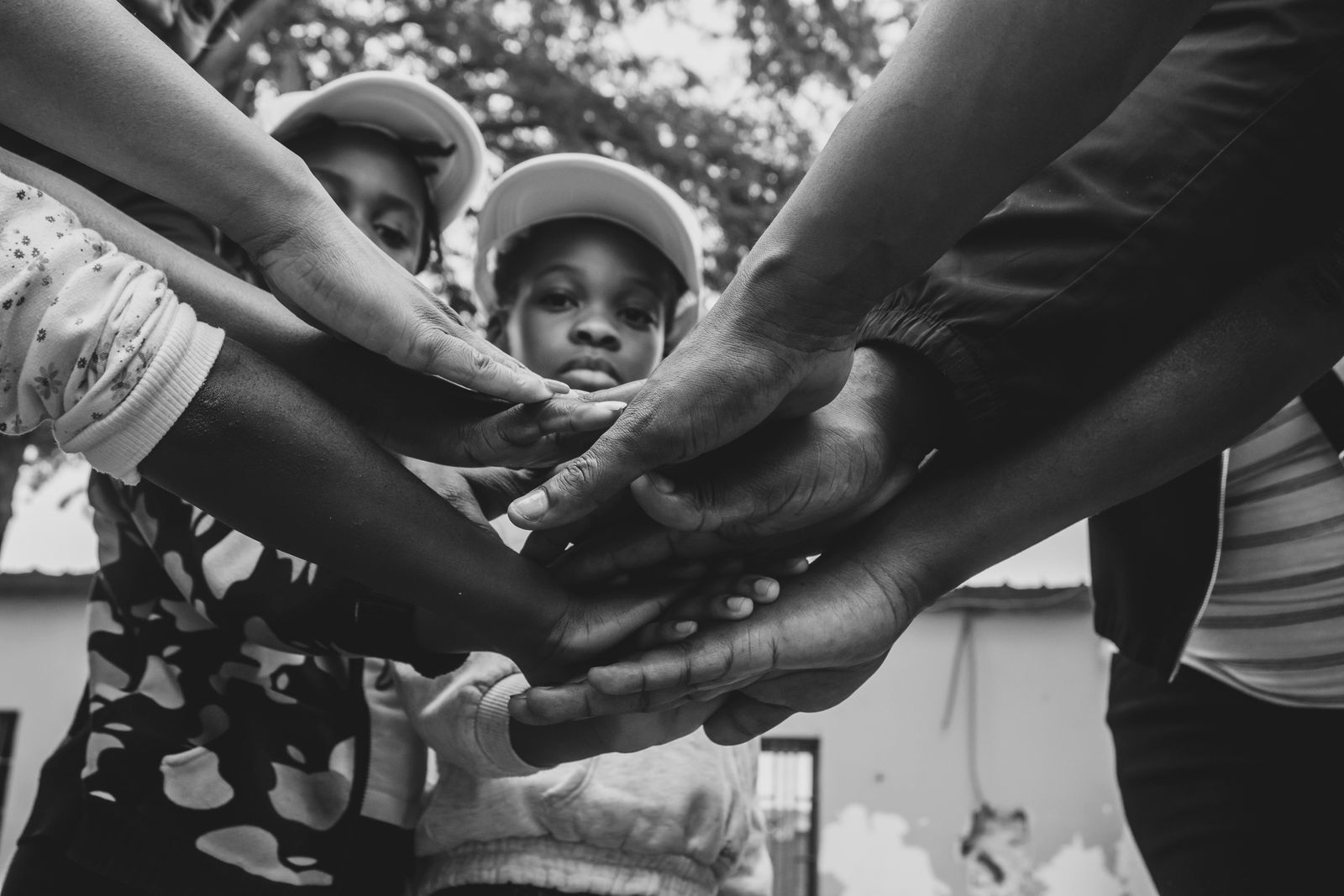 Volunteers joining hands together