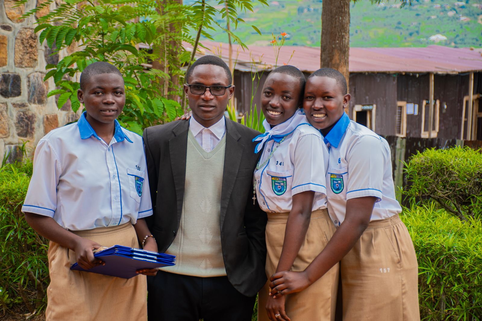 A teacher standing with students in a school garden